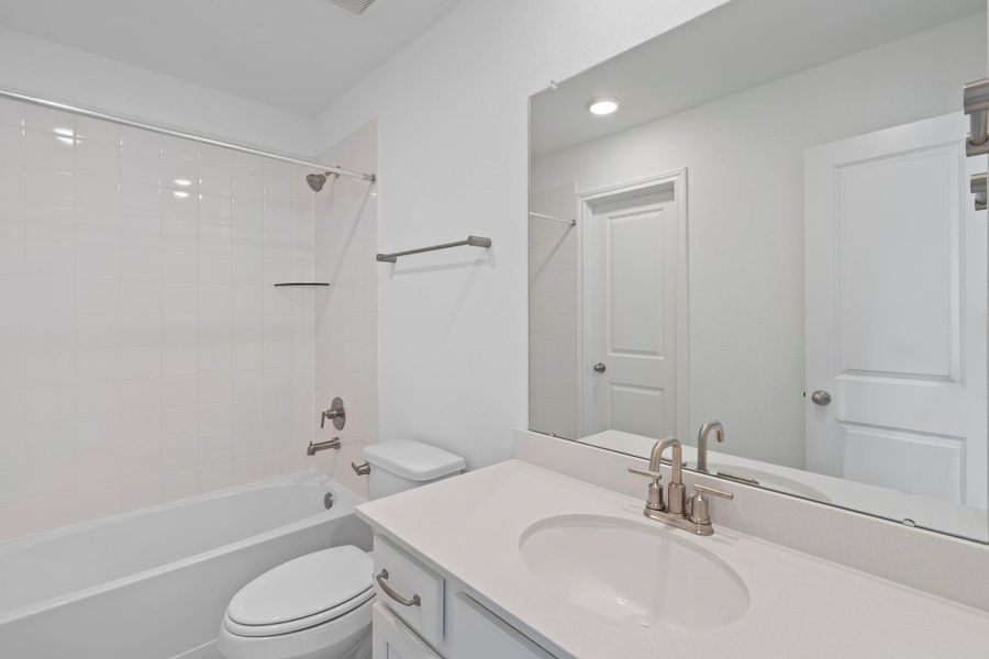 The secondary bath features tile flooring, white cabinetry and light countertops and a shower/tub combo. Perfect for accommodating any visiting family and friends. The secondary bath features tile flooring, white cabinetry and light countertops and a shower/tub combo. Perfect for accommodating any visiting family and friends.