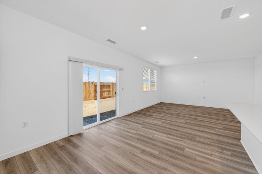A room with a wood floor and a wood floor with a window. A room with a wood floor and a wood floor with a window.