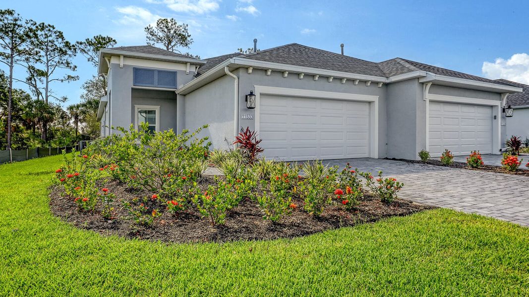 Front exterior of a new home in Wildleaf Real Estate and Homes for Sale in Parrish, FL - Neal Communities, Parrish, FL, highlighting curb appeal (Image 2). Front exterior of a new home in Wildleaf Real Estate and Homes for Sale in Parrish, FL - Neal Communities, Parrish, FL, highlighting curb appeal (Image 2).