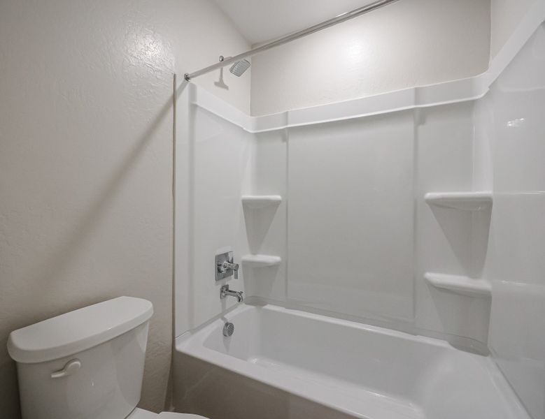 A bathroom with a tub toilet and sink.