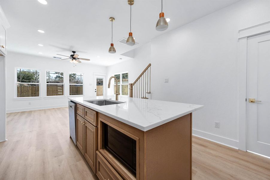 Another angle showing the island centerpiece and seamless open layout.