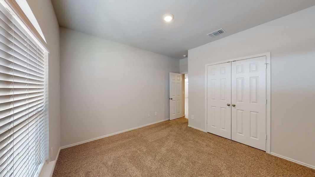 Unfurnished bedroom featuring carpet floors and a closet