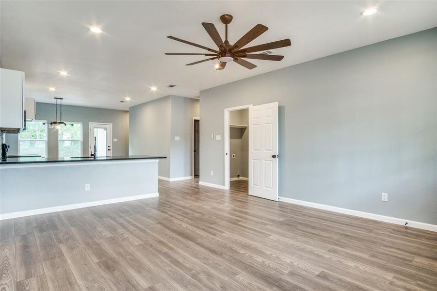 Unfurnished living room featuring light hardwood / wood-style flooring and ceiling fan