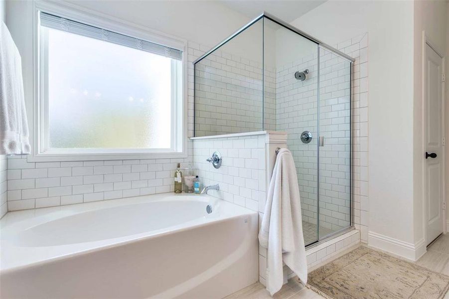 Bathroom featuring separate shower and tub and tile patterned flooring