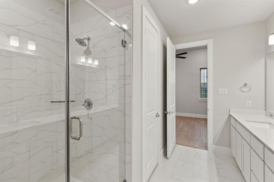 Bathroom featuring vanity, ceiling fan, hardwood / wood-style flooring, and walk in shower