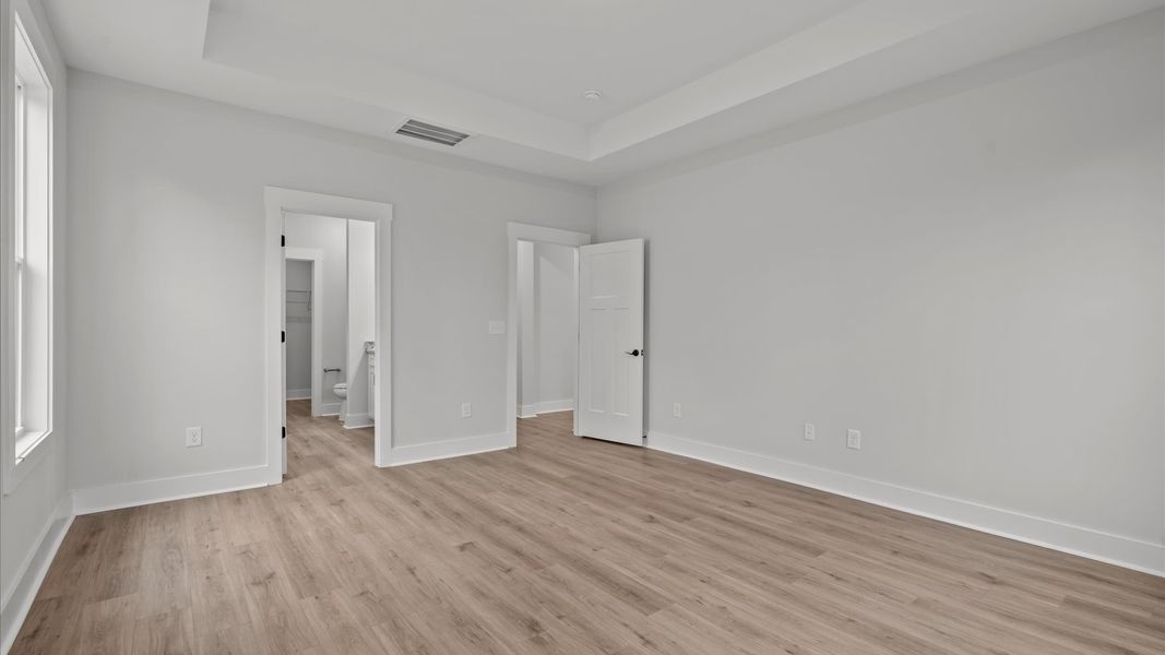 Primary suite with tray ceiling that offers first-rate relaxation with established style and elevated finishes