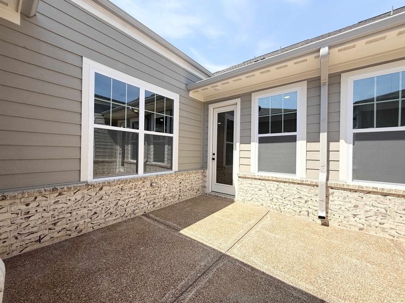 Property entrance featuring a patio