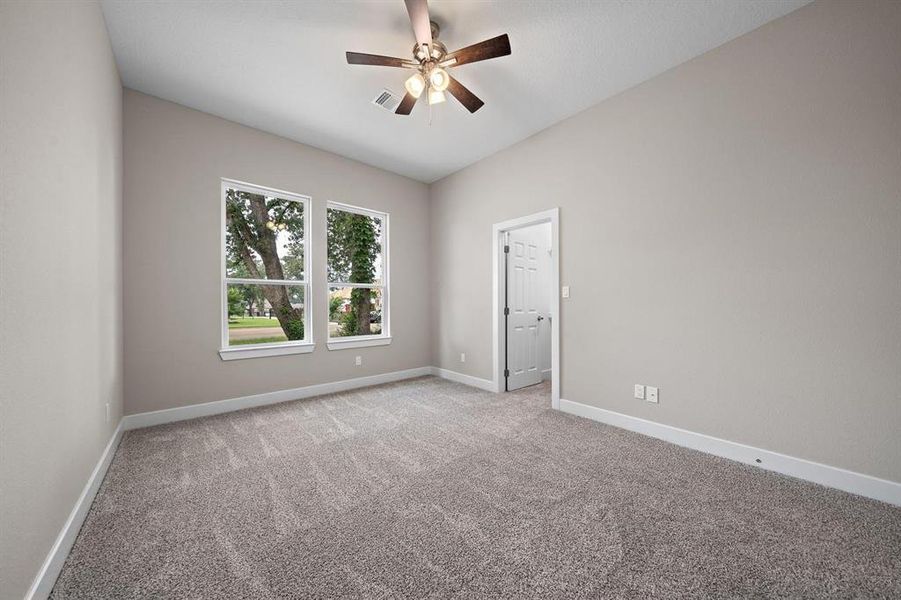 Bed 3 is behind the kitchen and is a large 14 x 13 with a custom built closet. Thick, plush carpet and a 44 in Hampton ceiling fan make this a perfect teenager hideaway or private guest room.