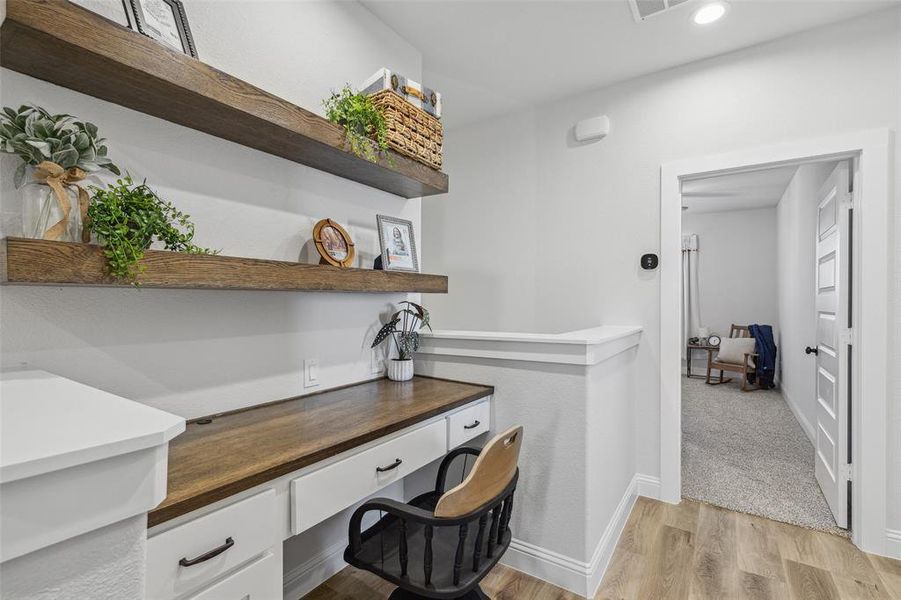 Carpeted office featuring built in desk