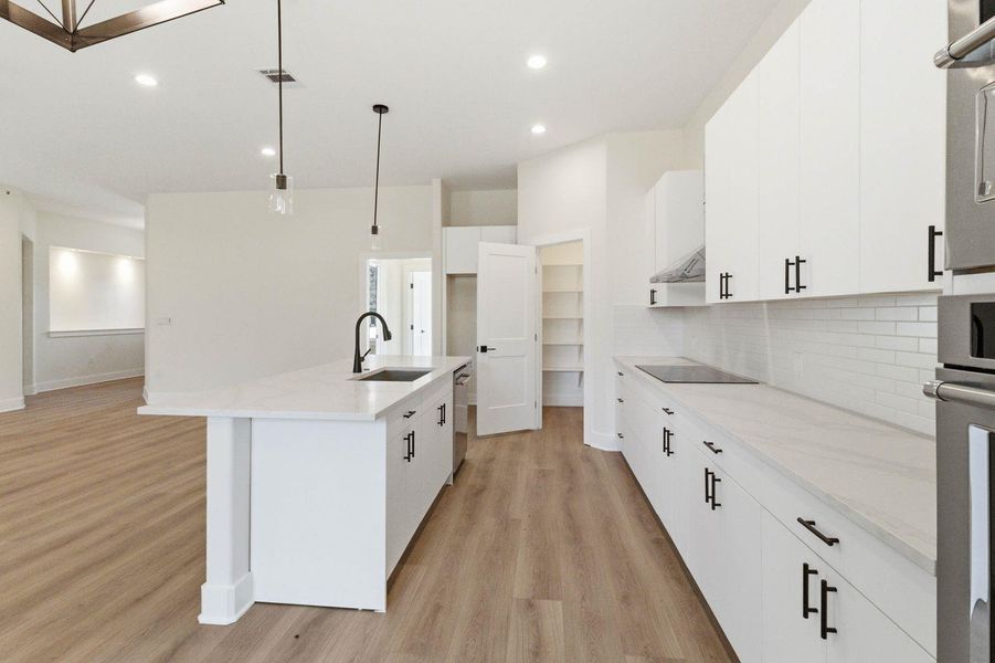 Culinary creations come to life in this kitchen, boasting an island, sleek appliances, and plentiful storage. Culinary creations come to life in this kitchen, boasting an island, sleek appliances, and plentiful storage.