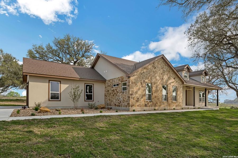 Front exterior of a new home in , Floresville, TX, highlighting curb appeal (Image 22).