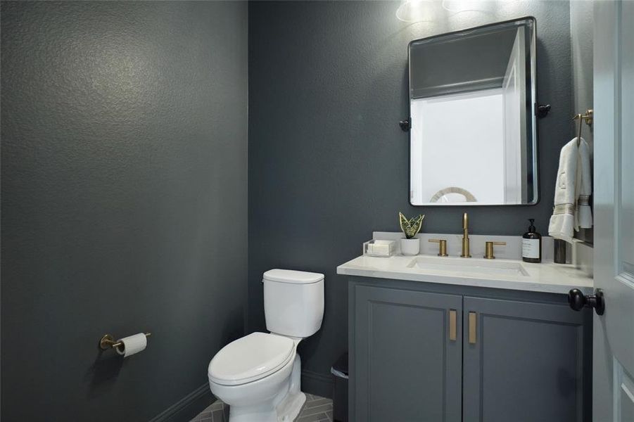 Bathroom featuring vanity, tile patterned flooring, and toilet