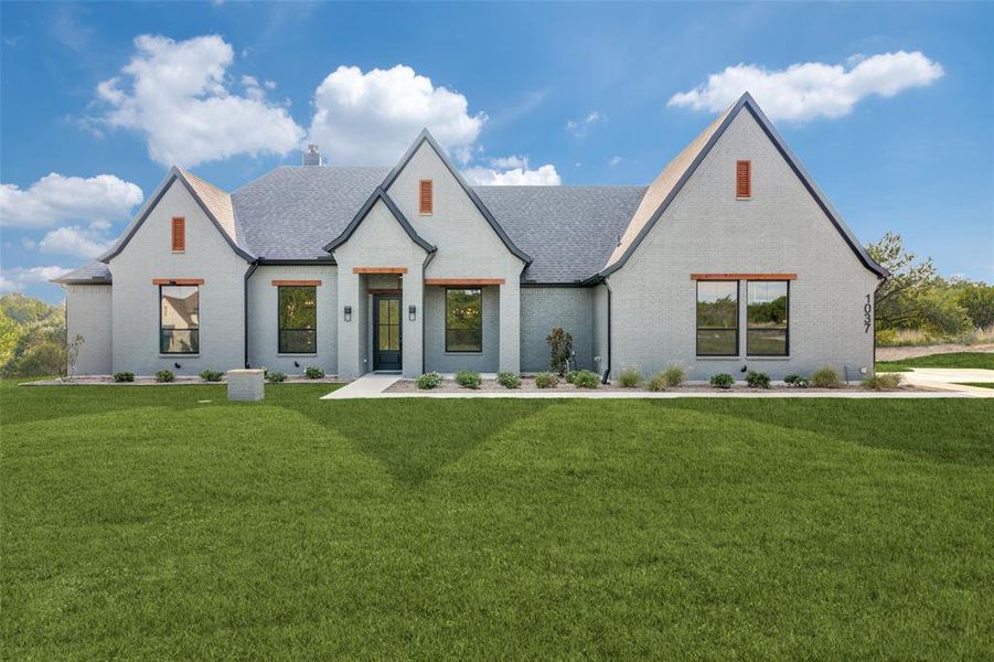 Front exterior of a new home in Woodland Lakes, Weatherford, TX, highlighting curb appeal (Image 1). Front exterior of a new home in Woodland Lakes, Weatherford, TX, highlighting curb appeal (Image 1).