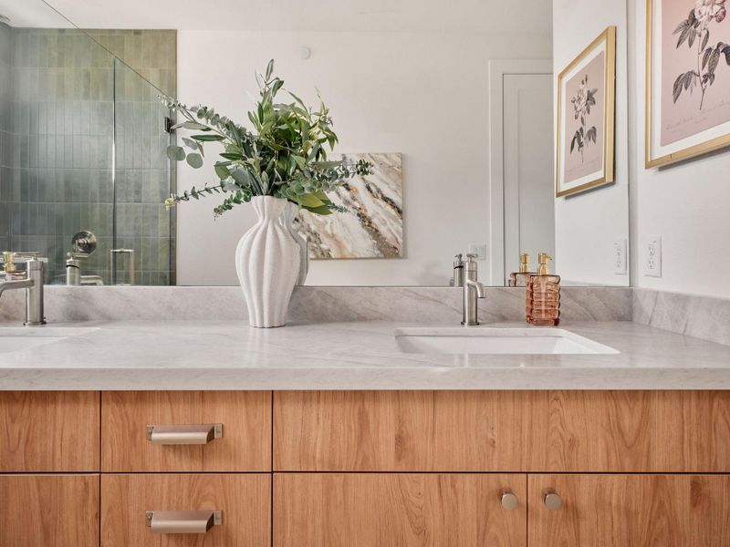 Bathroom featuring double vanity and a stall shower