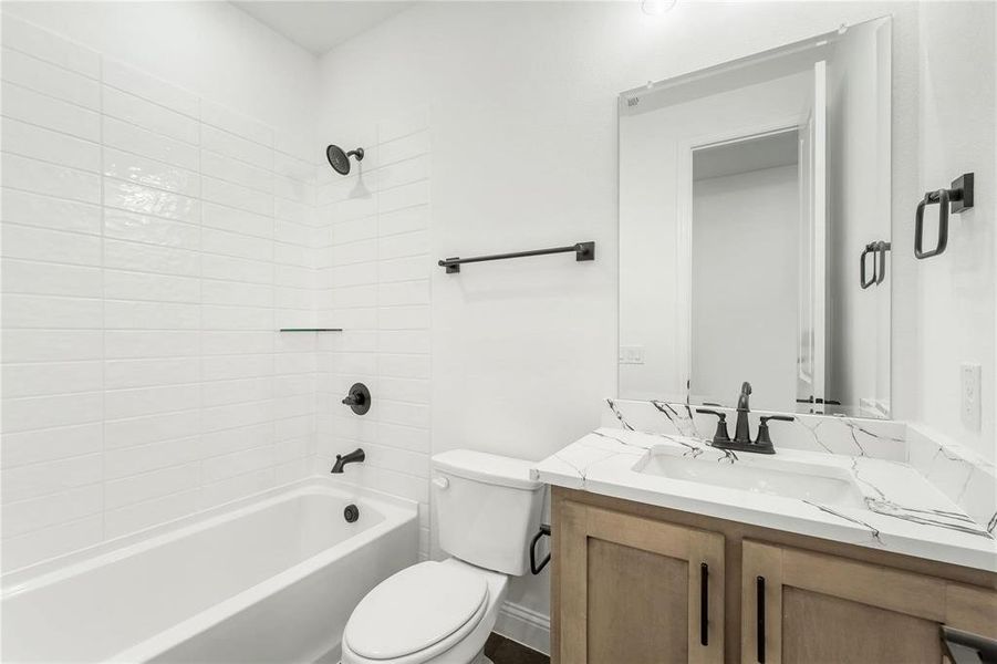 This full bath is located downstairs, and offers easy access to the second downstairs bedroom.