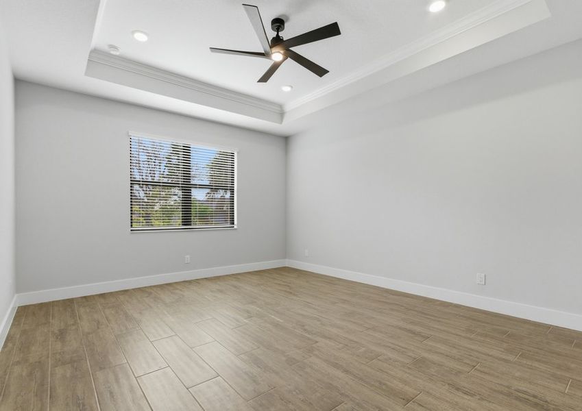 Master bedroom with a ceiling fan. Master bedroom with a ceiling fan.