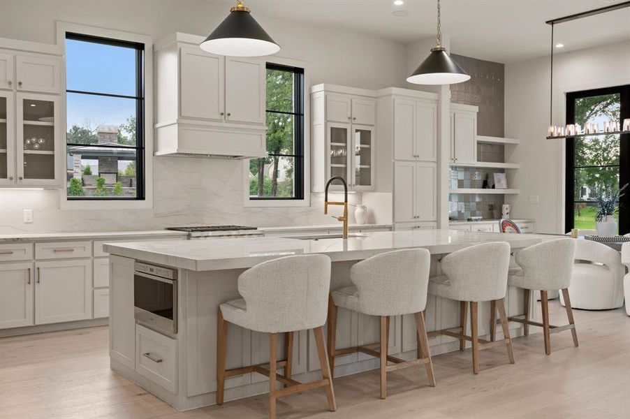 Kitchen with a sink, tasteful backsplash, a kitchen island with sink, and recessed lighting Kitchen with a sink, tasteful backsplash, a kitchen island with sink, and recessed lighting