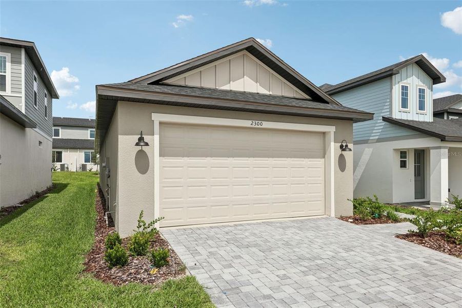 Front exterior of a new home in Cyrene at Minneola, Minneola, FL, highlighting curb appeal (Image 21).