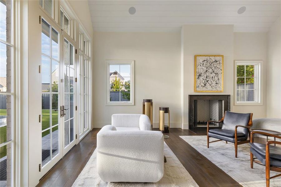 Living area featuring wood finished floors and french doors Living area featuring wood finished floors and french doors