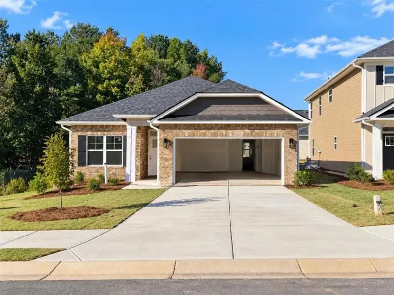 Front exterior of a new home in Canterbury Villas, Carrollton, GA, highlighting curb appeal (Image 1). Front exterior of a new home in Canterbury Villas, Carrollton, GA, highlighting curb appeal (Image 1).