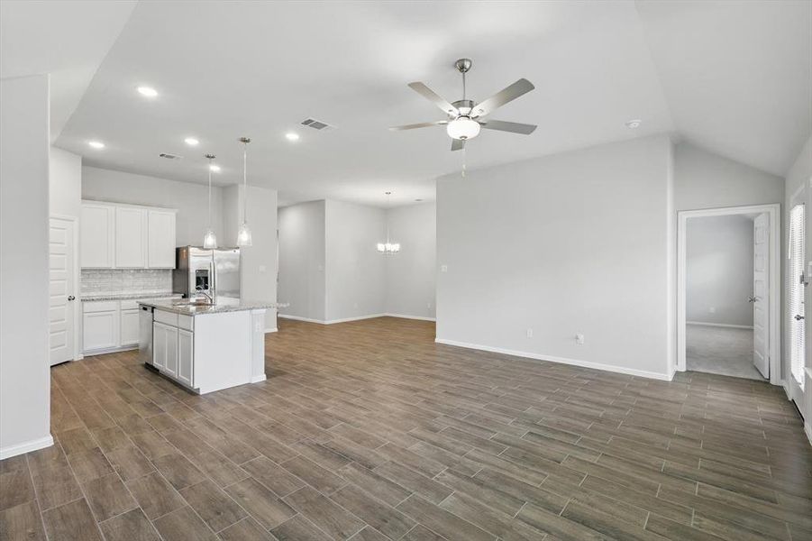 Kitchen with appliances with stainless steel finishes, a ceiling fan, open floor plan, dark wood finished floors, and recessed lighting Kitchen with appliances with stainless steel finishes, a ceiling fan, open floor plan, dark wood finished floors, and recessed lighting