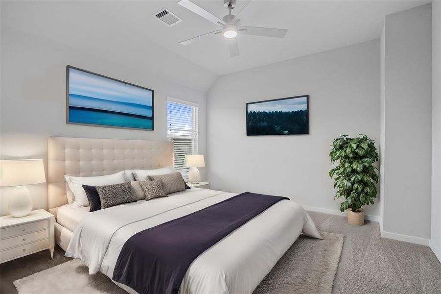 Secondary bedroom features plush carpet, custom paint, ceiling fan with lighting and large windows with privacy blinds.