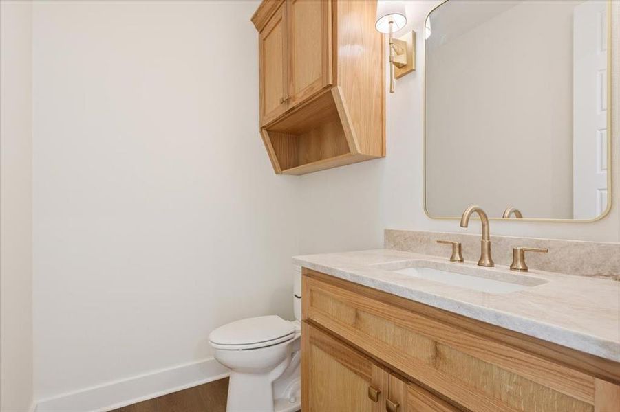 Bathroom featuring vanity and dark wood finished floors