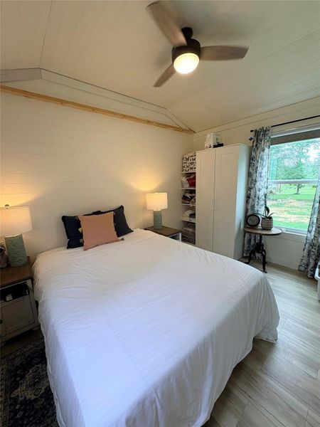 Spacious primary bedroom, with natural light.