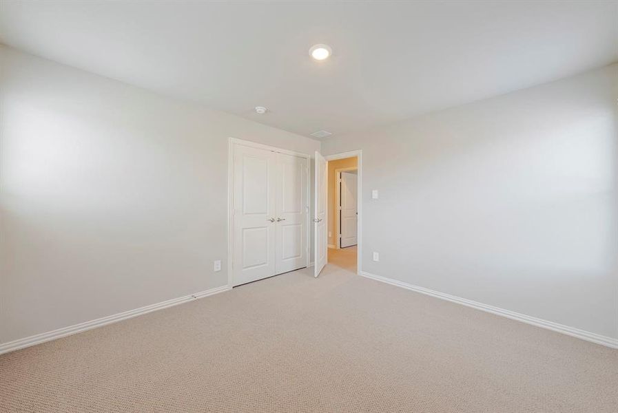 Empty room featuring carpet and baseboards Empty room featuring carpet and baseboards