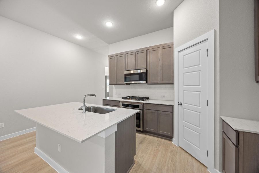 Kitchen in the Cypress home plan by Trophy Signature Homes - REPRESENTATIVE PHOTO Kitchen in the Cypress home plan by Trophy Signature Homes - REPRESENTATIVE PHOTO