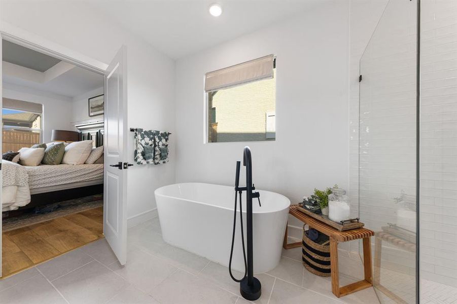 Primary bathroom with soaking tub, walk-in shower, double vanities, and generous closet space