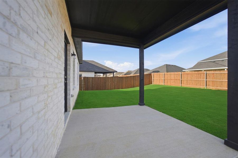 Covered patio featuring concrete flooring and dark support columns