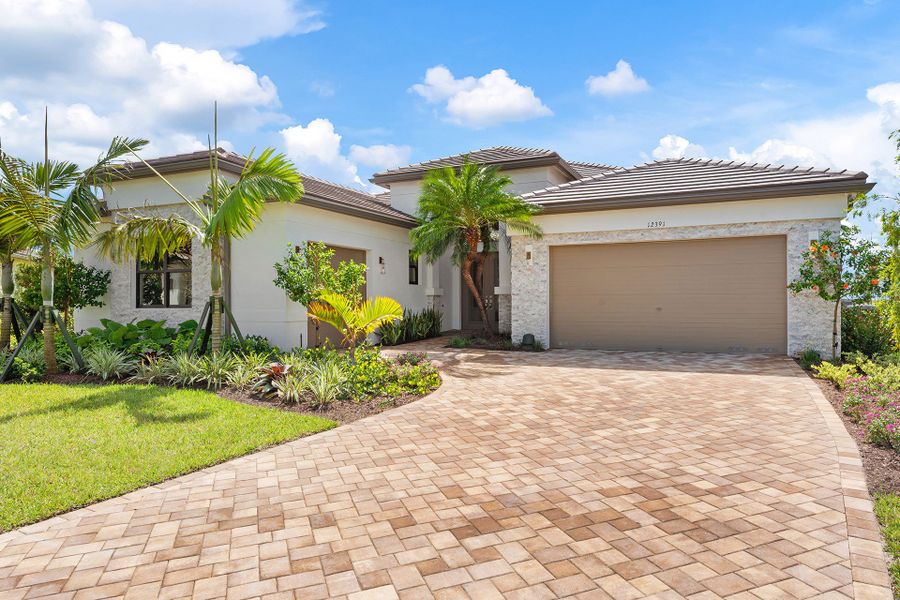 Front exterior of a new home in Valencia Parc at Riverland, Port St. Lucie, FL, highlighting curb appeal (Image 1).