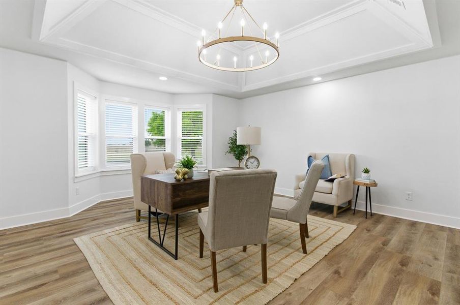 The property features light wood flooring, a decorative ceiling with a central chandelier, and a bay window providing natural light The property features light wood flooring, a decorative ceiling with a central chandelier, and a bay window providing natural light