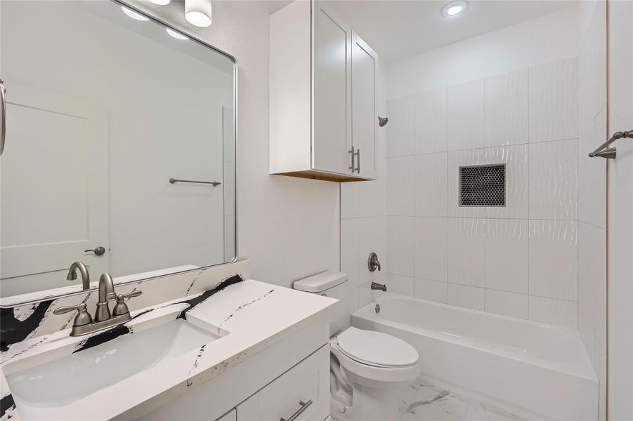 Bathroom #2 featuring vanity, washtub / shower combination, and recessed lighting