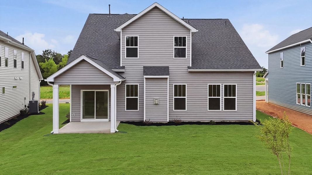 Warm and inviting outdoor living space with a covered rear porch and tasteful finishes at the Foxbank community