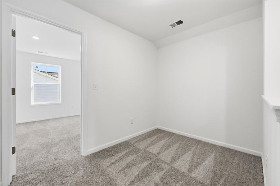Empty room featuring carpet and baseboards Empty room featuring carpet and baseboards