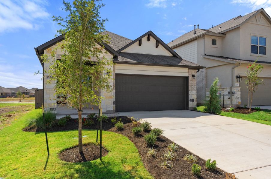 Front exterior of a new home in Flora, Hutto, TX, highlighting curb appeal (Image 23).