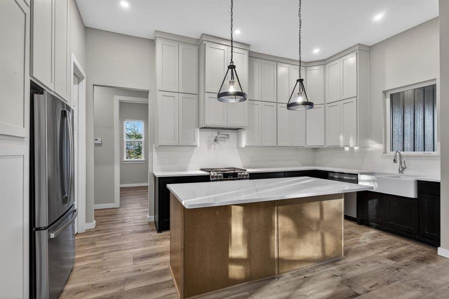 Stunning and unique kitchen with island, apron-front sink, gas cooktop, and an abundance of cabinet space!