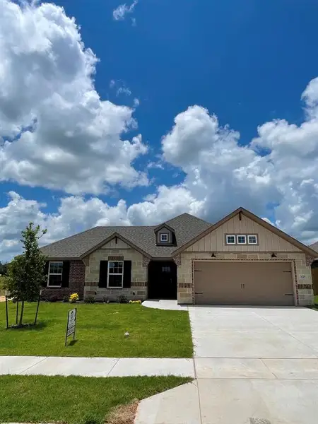 Front exterior of a new home in , Springtown, TX, highlighting curb appeal (Image 15).