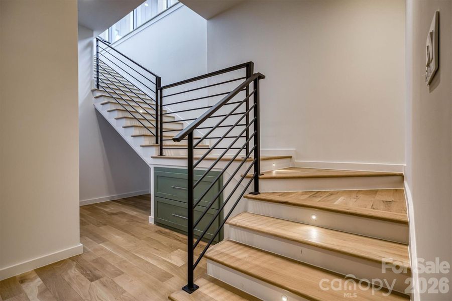 Custom metal railings and additional storage in stairwell