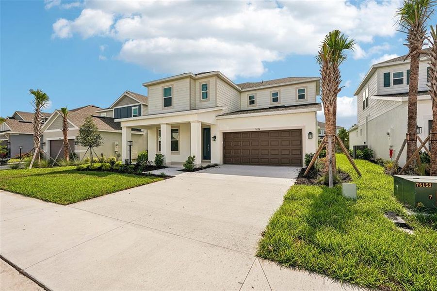 Front exterior of a new home in Tiburon, Nokomis, FL, highlighting curb appeal (Image 24).
