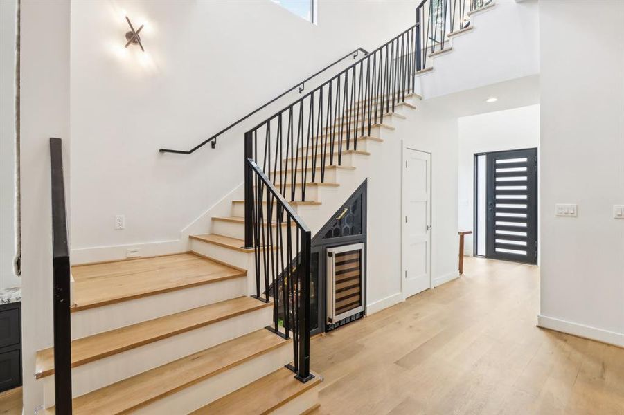 Custom iron railings flank the stairwell up to floor two.