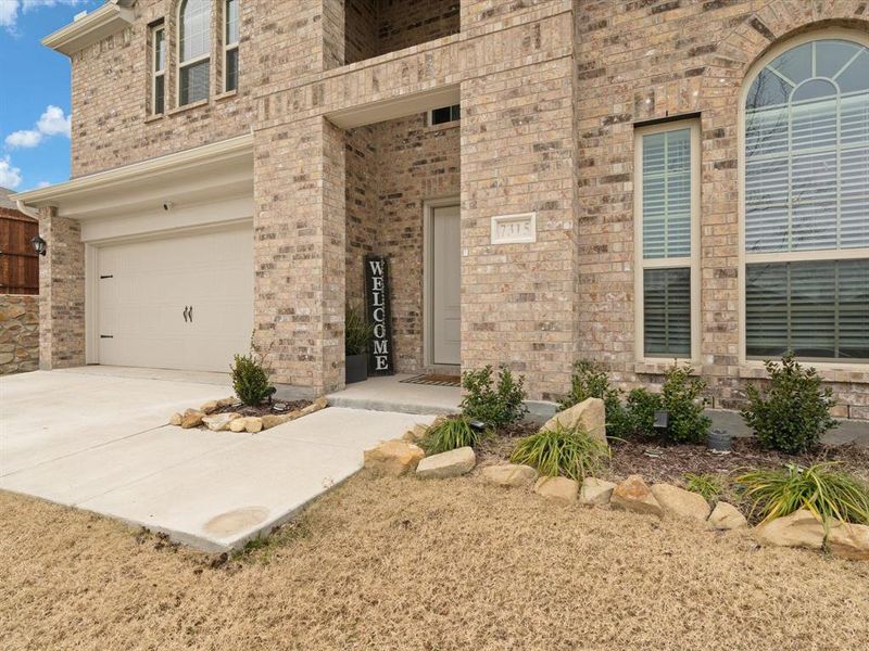 View of exterior entry with a garage