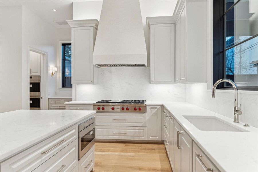 [Kitchen]This view reveals the walk-in pantry (left) with Wolfe wall ovens and warming drawer.