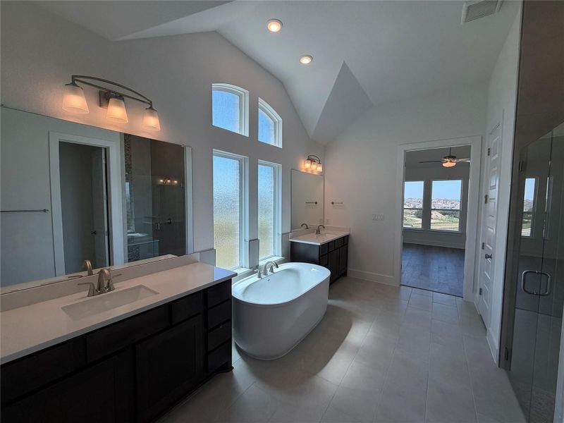Primary Bath retreat with dual vanities, soaking tub & walk-in shower Primary Bath retreat with dual vanities, soaking tub & walk-in shower