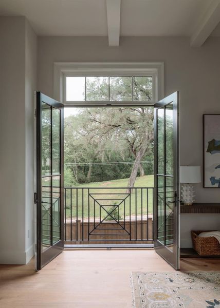 Juliet balcony with transom window and functioning doors.