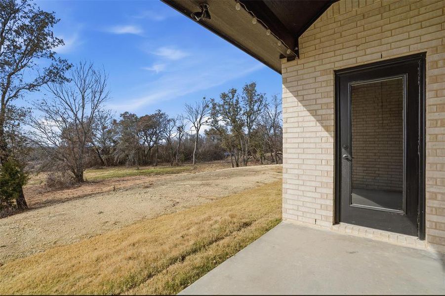 Exterior details and patio area of a home in Whispering Winds, Springtown (Image 3).