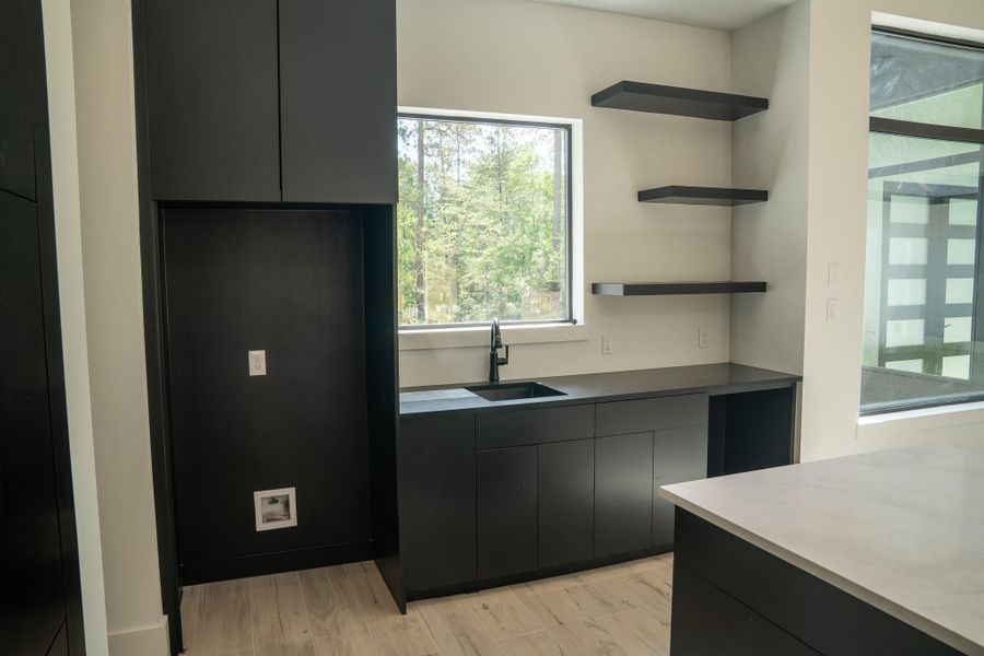 Coffee bar featuring a sink and pre-wiring for a mini-fridge, perfect for cold beverages.