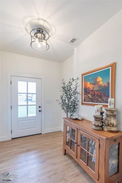 Doorway to outside featuring wood finished floors Doorway to outside featuring wood finished floors